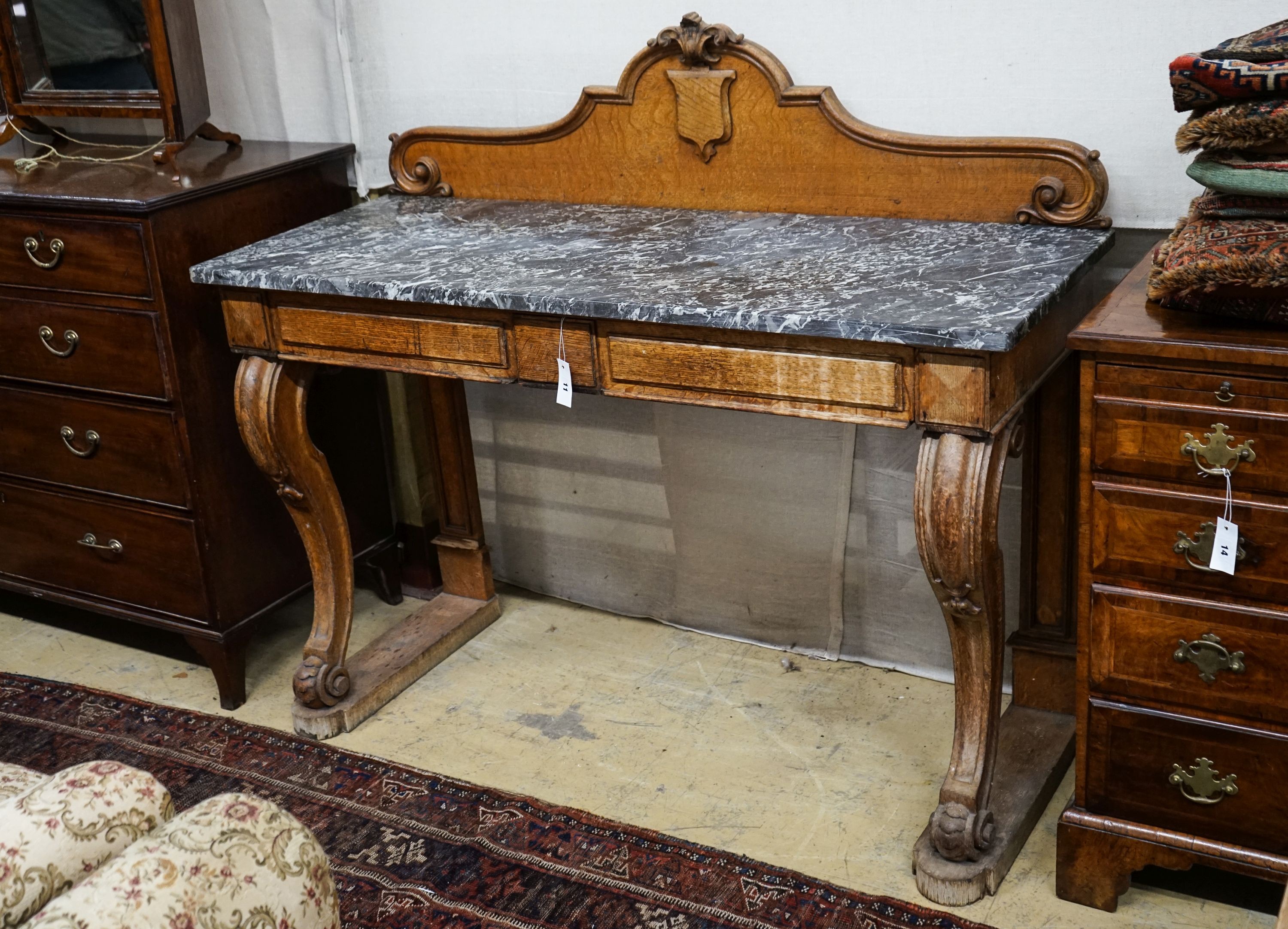 A mid Victorian oak marble topped two drawer console table, width 138cm, depth 54cm, height 120cm